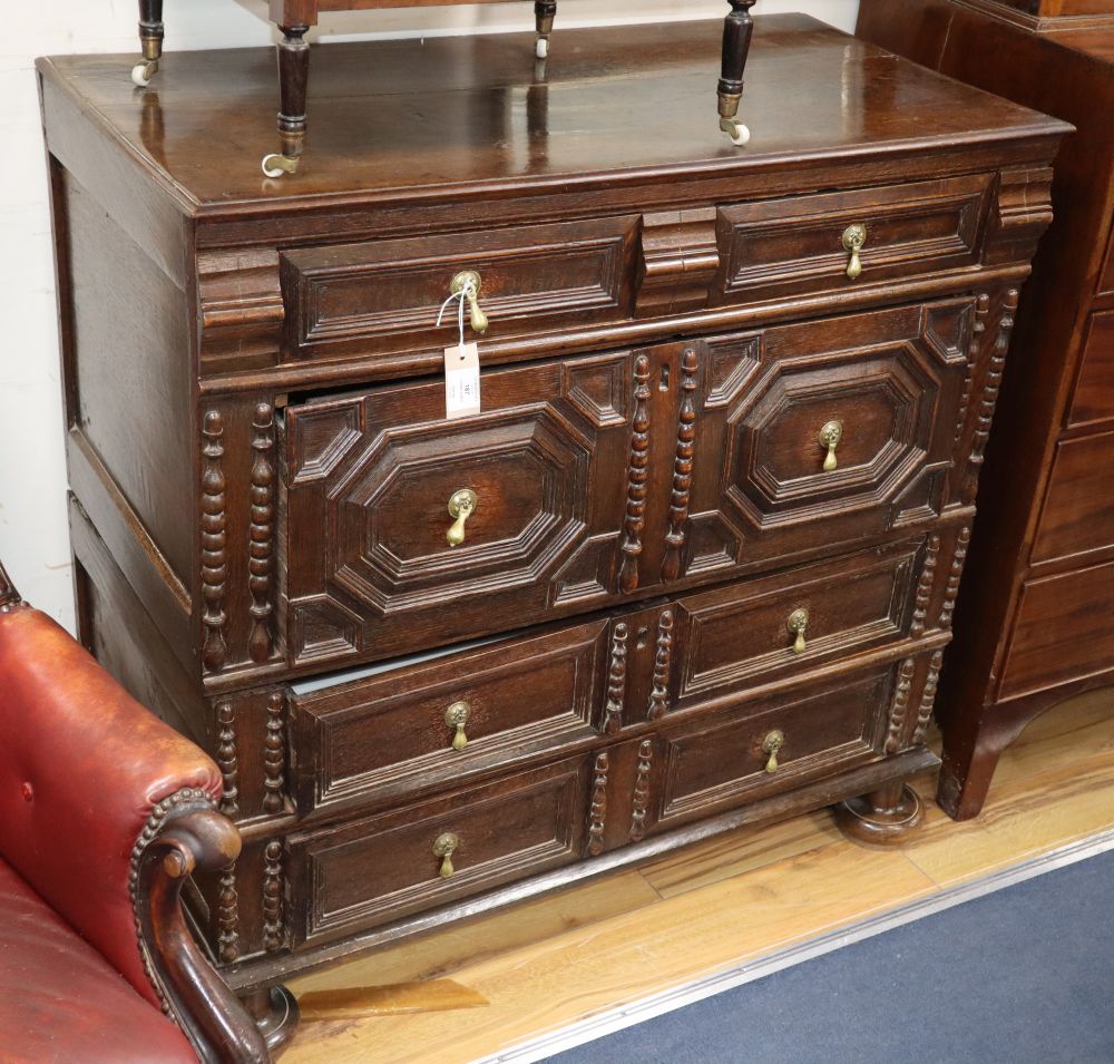 A 17th / 18th century geometric moulded oak two part chest, W.98cm, D.49cm, H.97cm